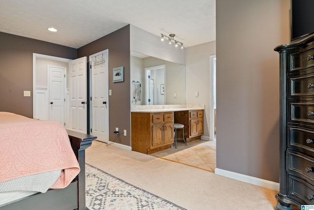 bathroom with recessed lighting, vanity, and baseboards
