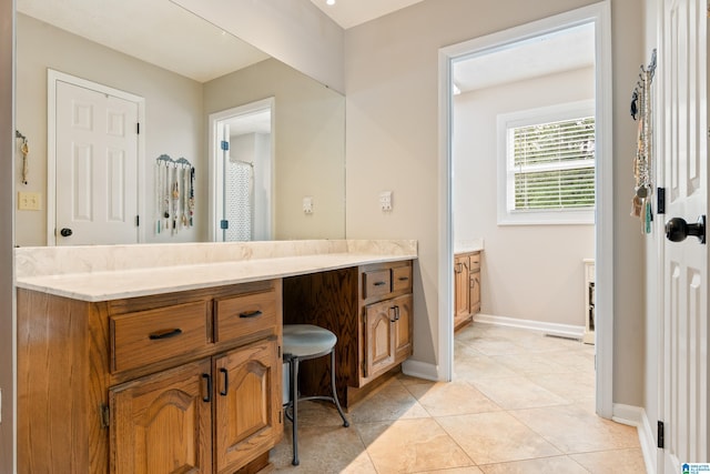 full bathroom featuring vanity, tile patterned flooring, and baseboards