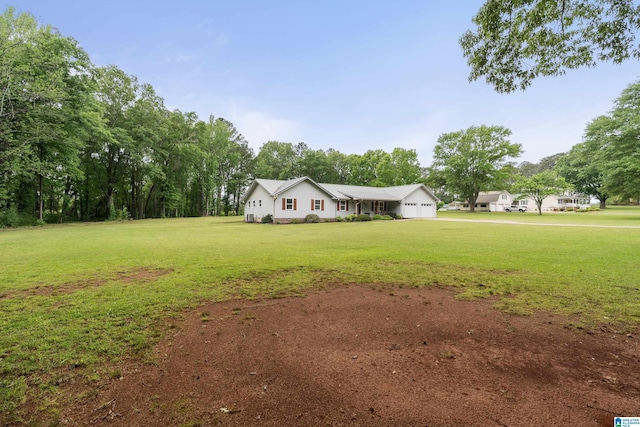 view of yard with driveway and a garage