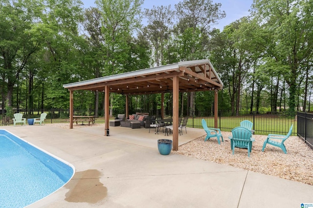 view of swimming pool with a patio, outdoor lounge area, a fenced in pool, and fence