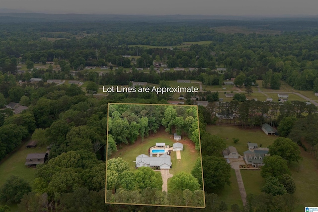 birds eye view of property with a wooded view