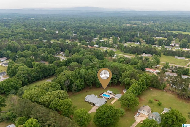 drone / aerial view featuring a wooded view
