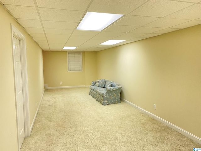 unfurnished room featuring carpet, a paneled ceiling, and baseboards
