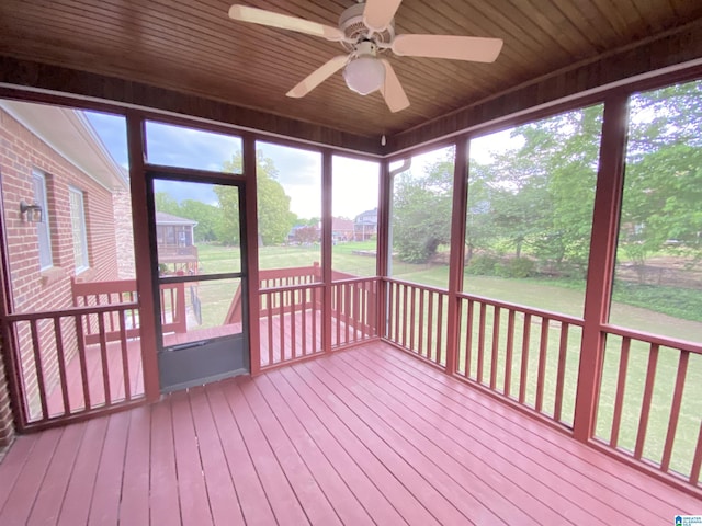 unfurnished sunroom featuring ceiling fan and plenty of natural light