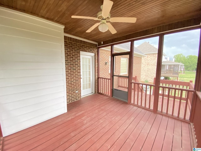 unfurnished sunroom with ceiling fan