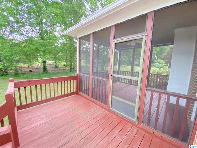 wooden deck with a sunroom and fence