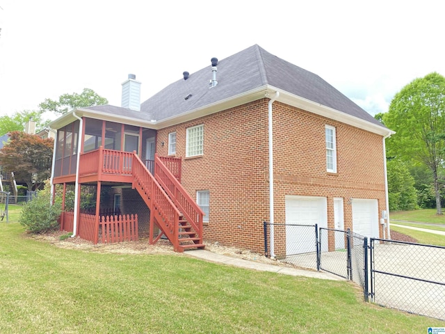 rear view of property featuring a gate, brick siding, fence, a garage, and a sunroom