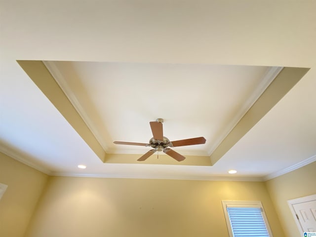 interior details with ornamental molding, recessed lighting, ceiling fan, and a tray ceiling