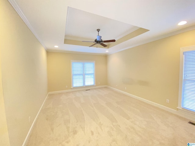 unfurnished room with crown molding, light colored carpet, and baseboards