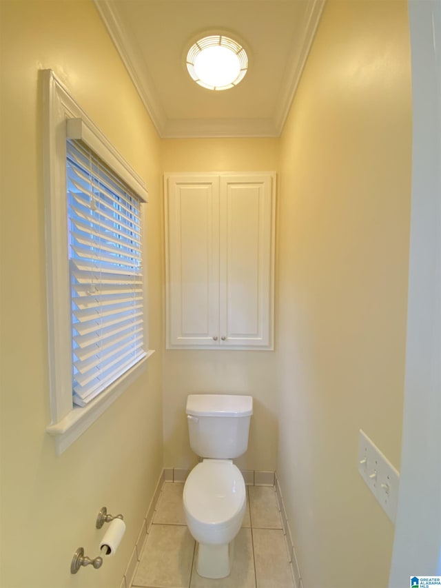 bathroom featuring tile patterned floors, baseboards, toilet, and crown molding