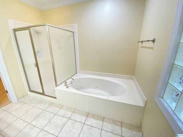 bathroom featuring a stall shower, tile patterned flooring, and a tub with jets