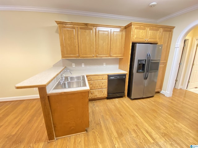 kitchen featuring a sink, light countertops, arched walkways, dishwasher, and stainless steel fridge with ice dispenser