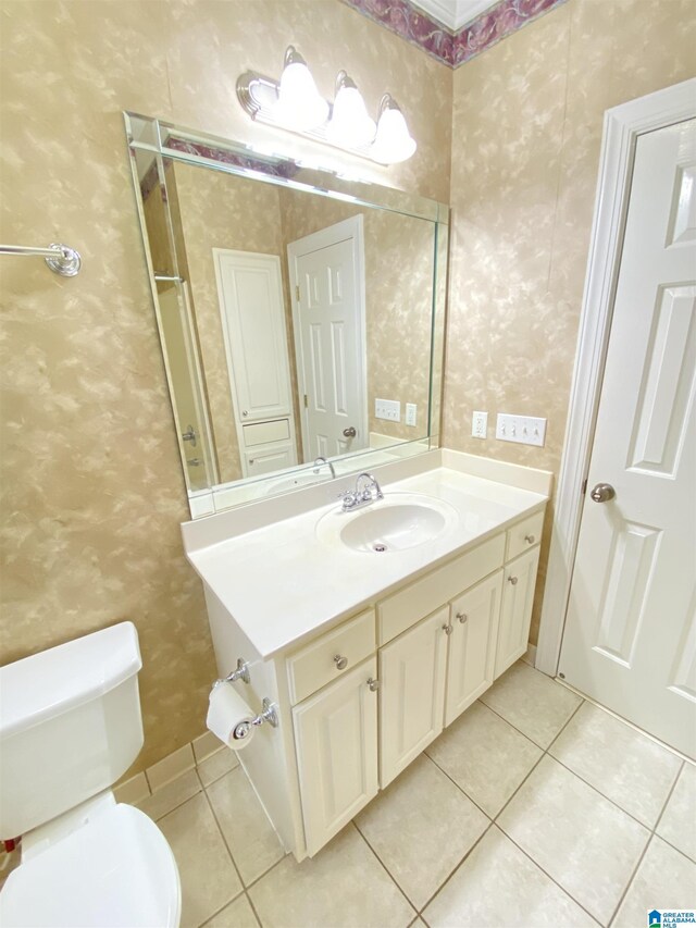 bathroom with toilet, tile patterned flooring, wallpapered walls, and vanity