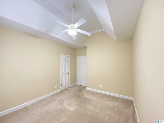 unfurnished room featuring baseboards, light carpet, ceiling fan, and vaulted ceiling