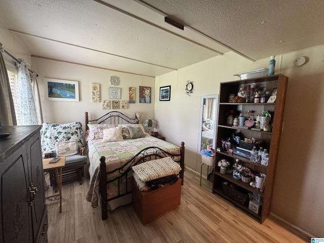 bedroom featuring a textured ceiling and light wood-style floors