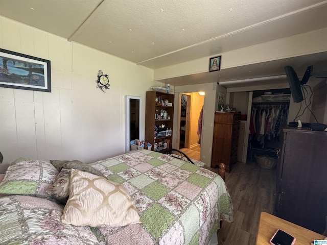 bedroom featuring wood finished floors and a closet
