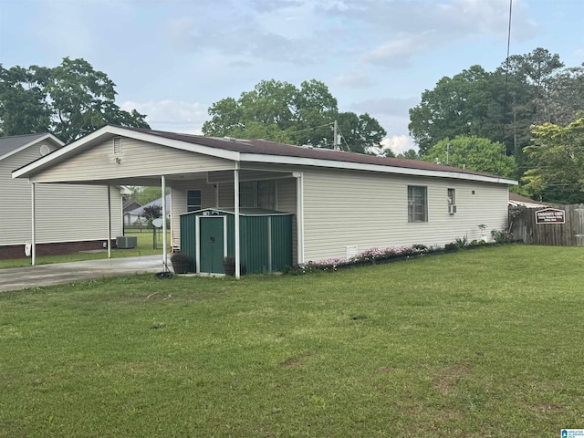 view of property exterior with fence, an outbuilding, an attached carport, a storage shed, and a lawn
