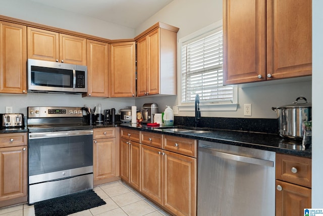 300 Stonecreek Cir, Helena, AL 35080 - kitchen with appliances with stainless steel finishes, light tile patterned floors, dark stone countertops, and a sink