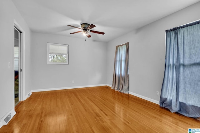 unfurnished bedroom featuring baseboards, visible vents, a ceiling fan, and light wood-type flooring