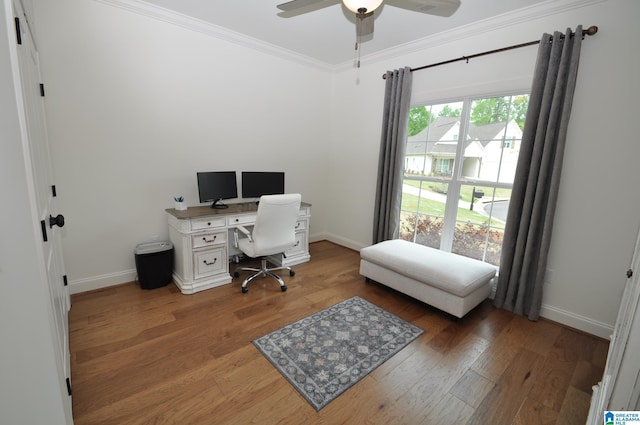 home office featuring wood finished floors, ceiling fan, ornamental molding, and baseboards