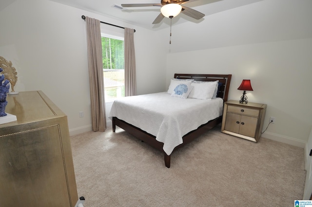 bedroom with baseboards, a ceiling fan, and light carpet