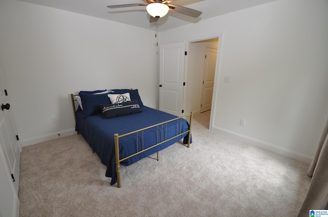 carpeted bedroom featuring a ceiling fan and baseboards