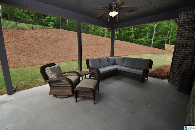 view of patio / terrace featuring fence, a ceiling fan, and an outdoor living space