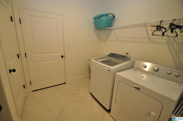 laundry room with washer and dryer, laundry area, and baseboards