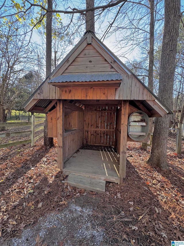 view of outbuilding with an outbuilding and fence