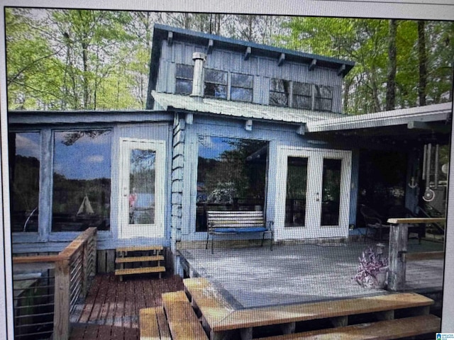 back of house featuring a sunroom