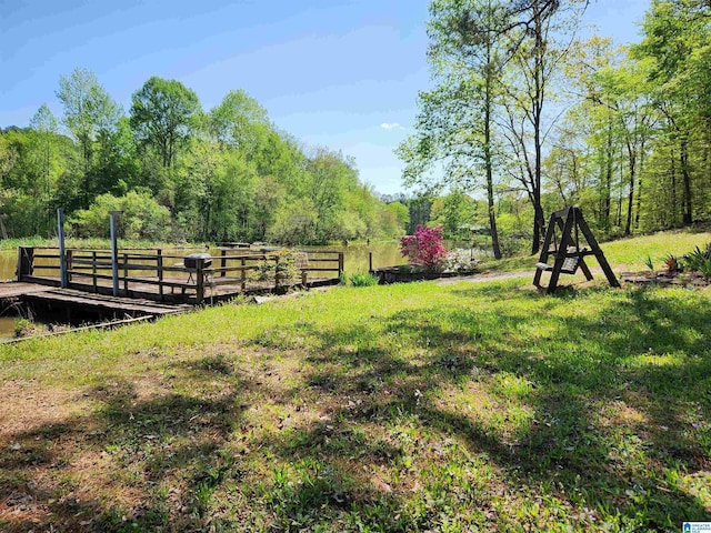 view of yard with a view of trees and fence