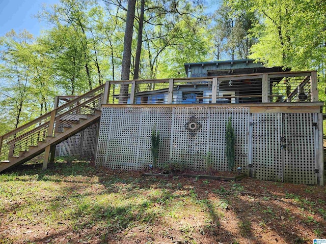 rear view of property featuring a deck and stairs