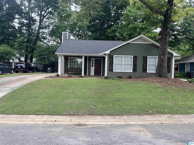 single story home with a front yard, driveway, a chimney, and covered porch