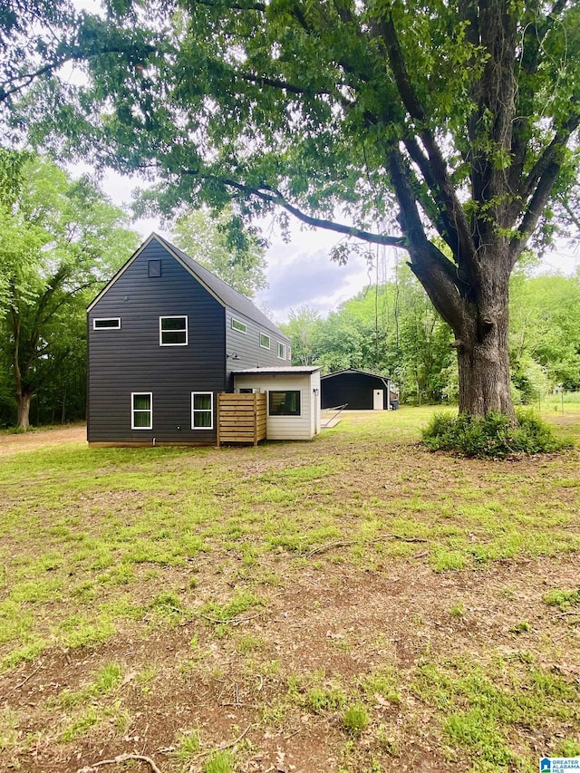 back of house with a yard and a detached carport