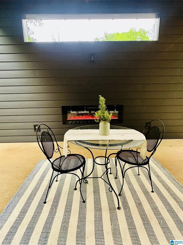 dining area with a glass covered fireplace and plenty of natural light