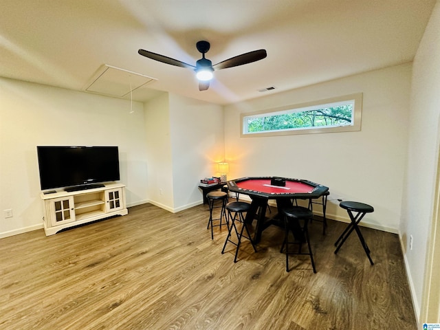 playroom with attic access, visible vents, wood finished floors, and baseboards