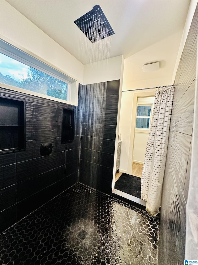 bathroom with a wealth of natural light and tiled shower