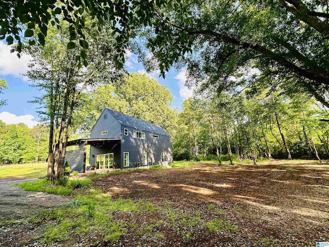 view of outbuilding with a forest view