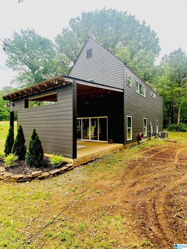 exterior space with a patio area and central AC unit