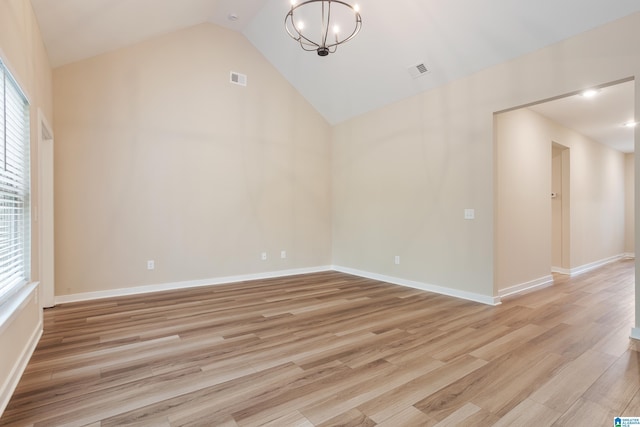 3757 Seaside Sparrow Cir, Bessemer, AL 35022 - empty room featuring plenty of natural light, a notable chandelier, light wood-style floors, and visible vents