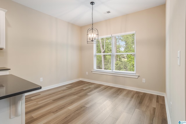 3757 Seaside Sparrow Cir, Bessemer, AL 35022 - unfurnished dining area with baseboards, visible vents, an inviting chandelier, and light wood-style floors