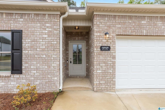 3757 Seaside Sparrow Cir, Bessemer, AL 35022 - view of exterior entry with concrete driveway, brick siding, and a garage