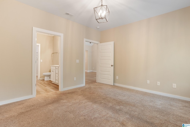 3757 Seaside Sparrow Cir, Bessemer, AL 35022 - unfurnished bedroom featuring connected bathroom, a chandelier, visible vents, light carpet, and baseboards
