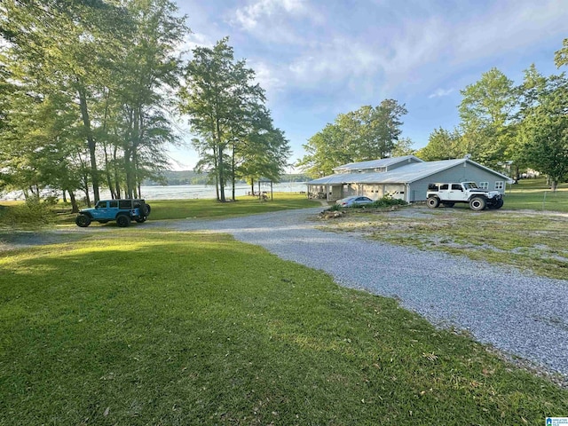 view of road with a water view and driveway