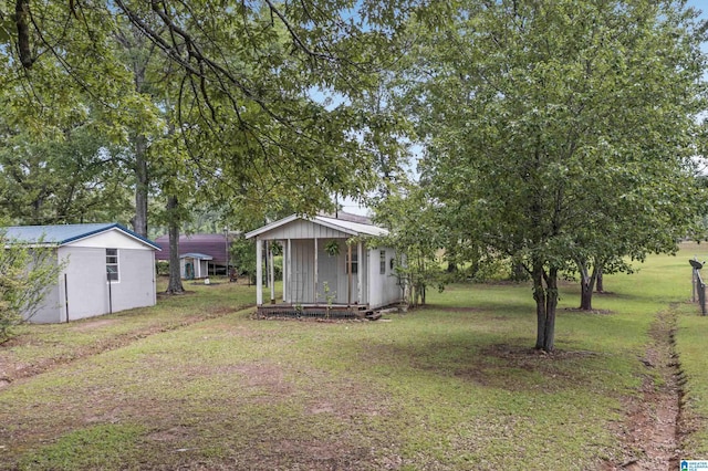 view of yard with a storage shed and an outdoor structure