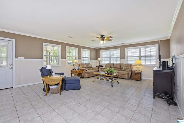 living area featuring ceiling fan, wainscoting, light tile patterned flooring, and visible vents