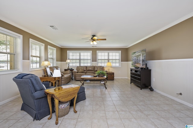 living room with visible vents, wainscoting, ceiling fan, and light tile patterned flooring