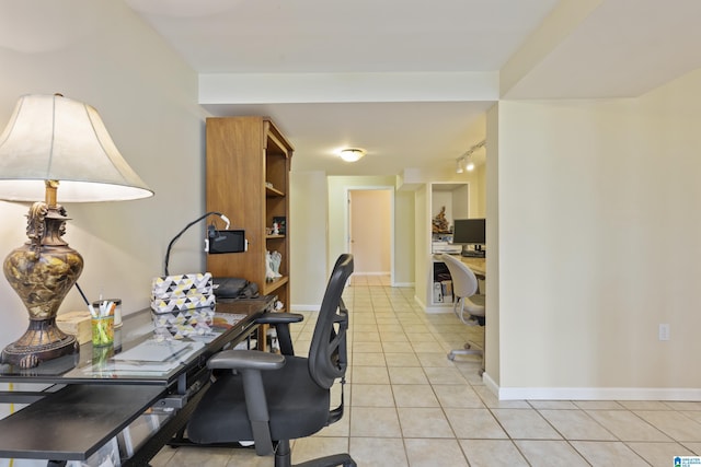 home office featuring baseboards, rail lighting, and light tile patterned floors