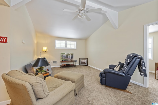 living room featuring carpet, lofted ceiling with beams, a ceiling fan, and a wealth of natural light