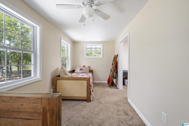 carpeted bedroom featuring baseboards and a ceiling fan